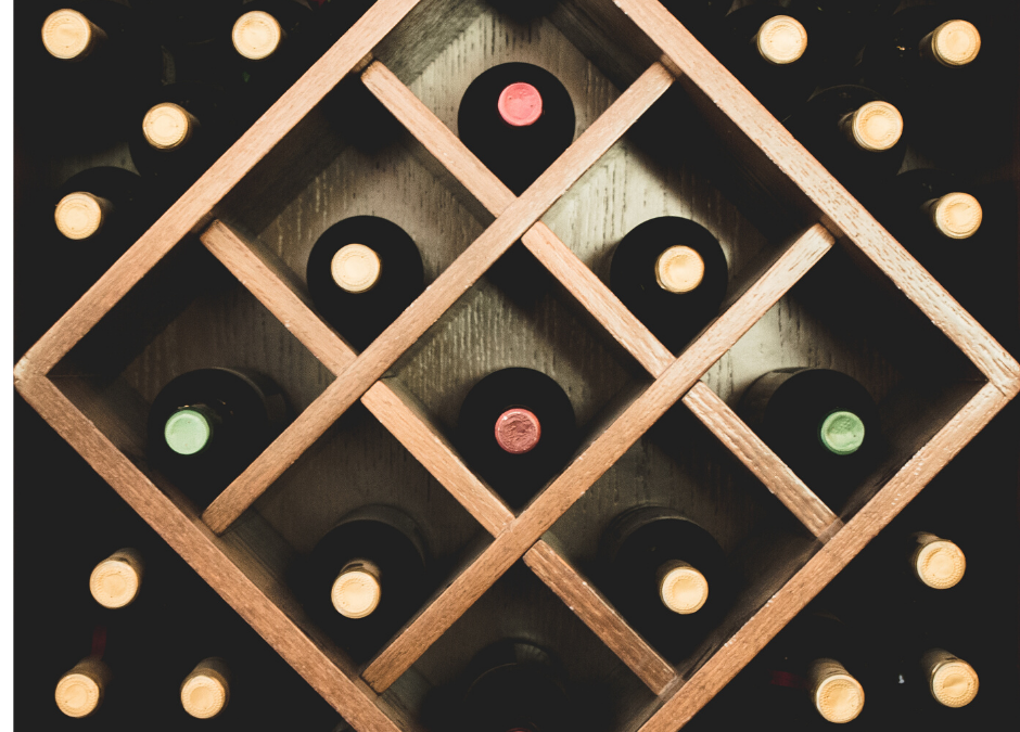 photo of wine bottles in wooden rack